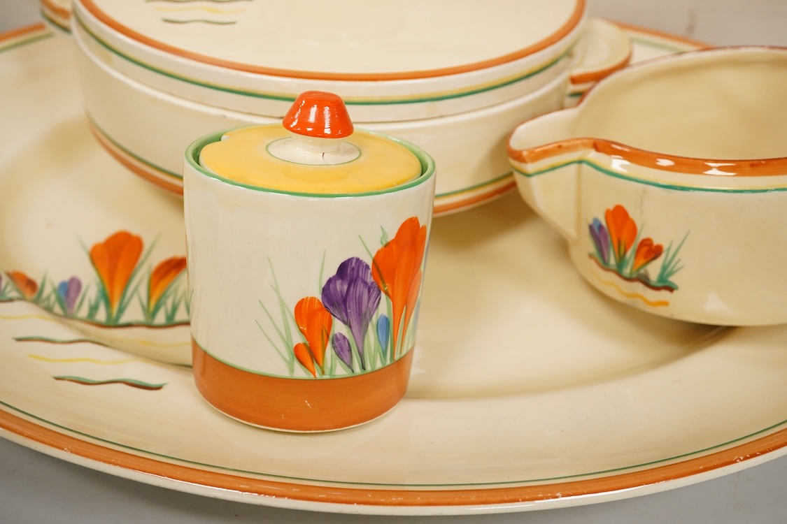A Clarice Cliff ‘crocus pattern’ tureen and cover, jug, honey pot with cover and an oval meat platter - 43cm wide